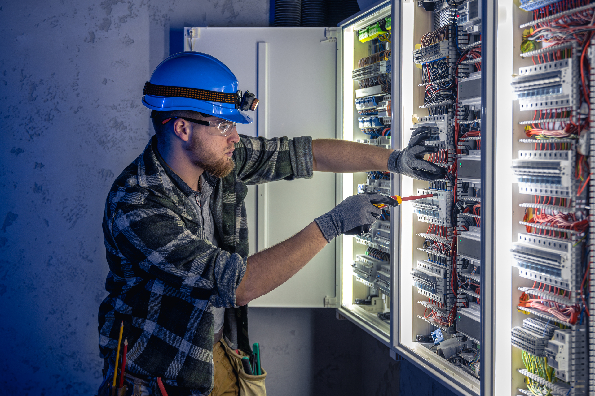 Engineer working on switchboard panel